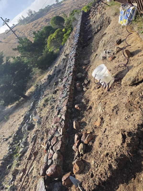 Hillside stone drainage wall